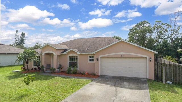 ranch-style house with a garage and a front yard