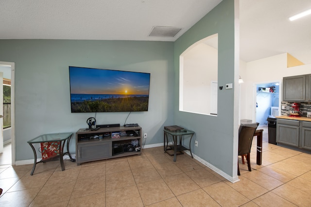 tiled living room with lofted ceiling