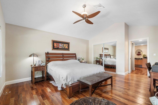 bedroom with hardwood / wood-style flooring, ceiling fan, lofted ceiling, and a closet