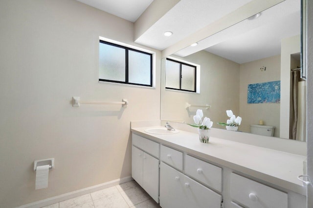 bathroom featuring tile patterned floors, vanity, and toilet