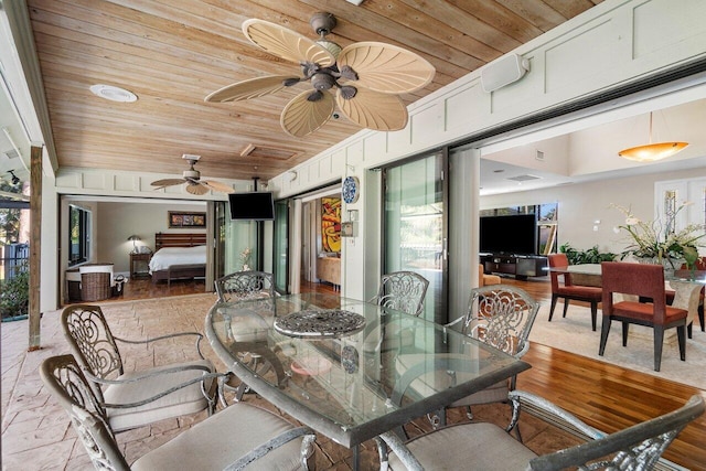 interior space with ceiling fan and wooden ceiling