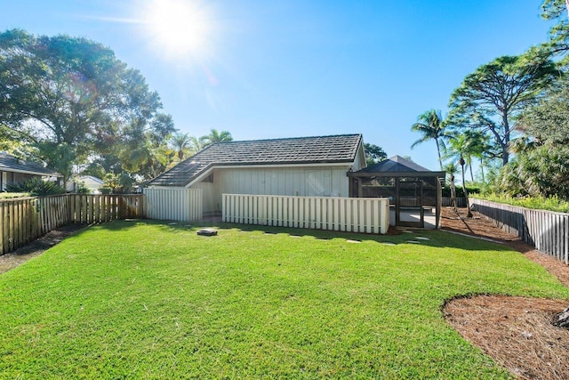 rear view of property with a gazebo and a lawn