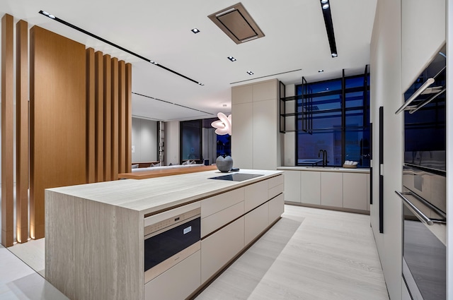 kitchen with double wall oven, a kitchen island, and butcher block counters