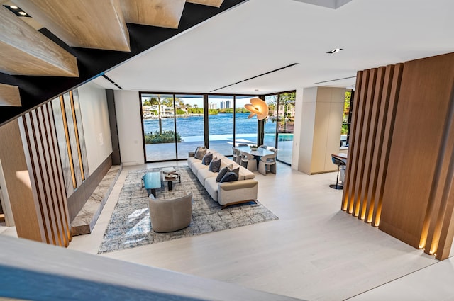 living room featuring floor to ceiling windows and a water view