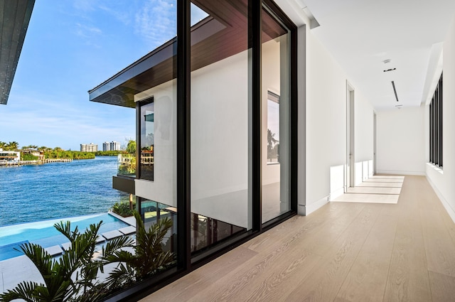 interior space featuring a water view and light hardwood / wood-style flooring