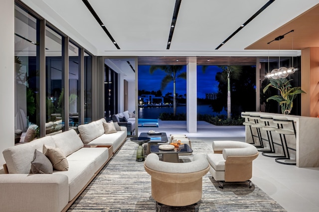 interior space with floor to ceiling windows and a notable chandelier