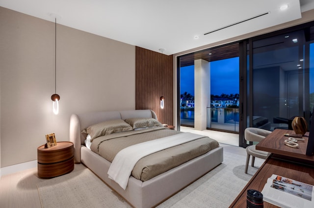 bedroom featuring access to outside and floor to ceiling windows