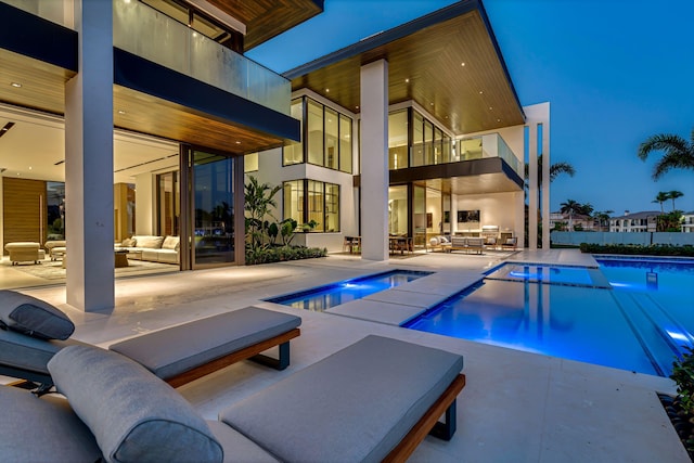 view of swimming pool featuring an in ground hot tub, an outdoor living space, and a patio area