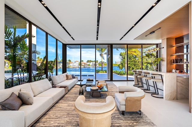 living room with a water view and a wall of windows