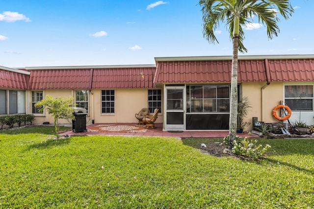 back of property featuring a lawn