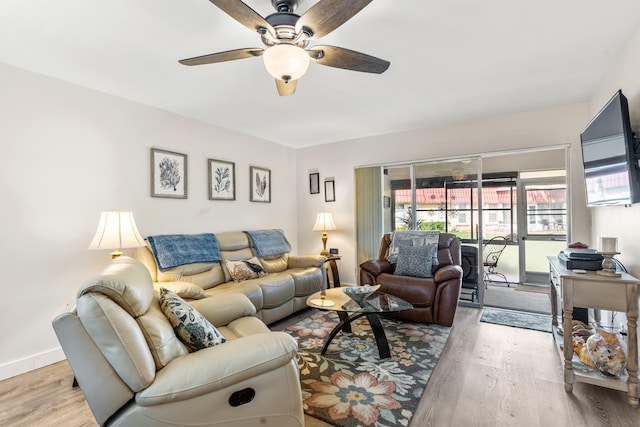 living room featuring light hardwood / wood-style floors and ceiling fan