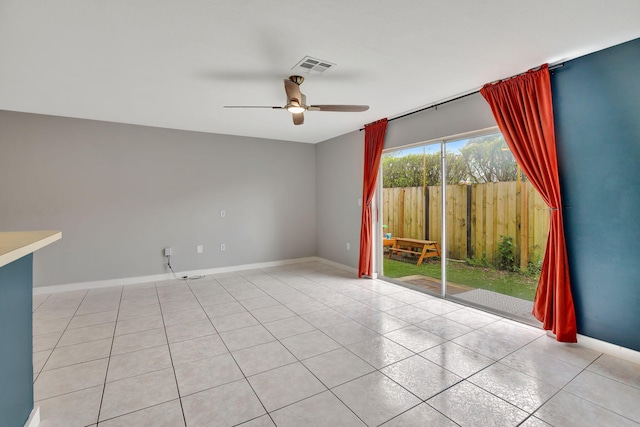 spare room with ceiling fan and light tile patterned floors