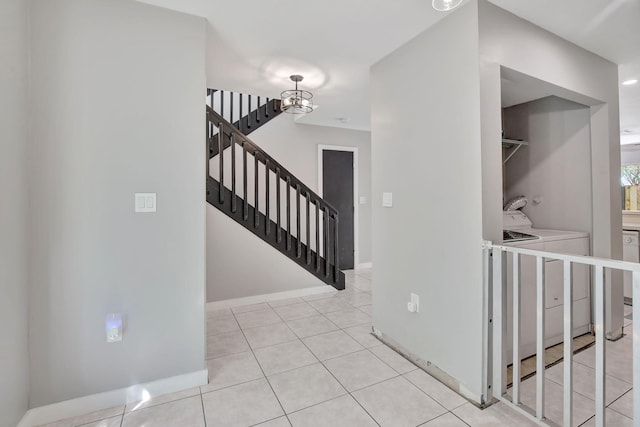 interior space featuring a chandelier, tile patterned floors, and washer and dryer