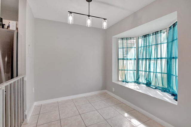 unfurnished dining area featuring light tile patterned floors