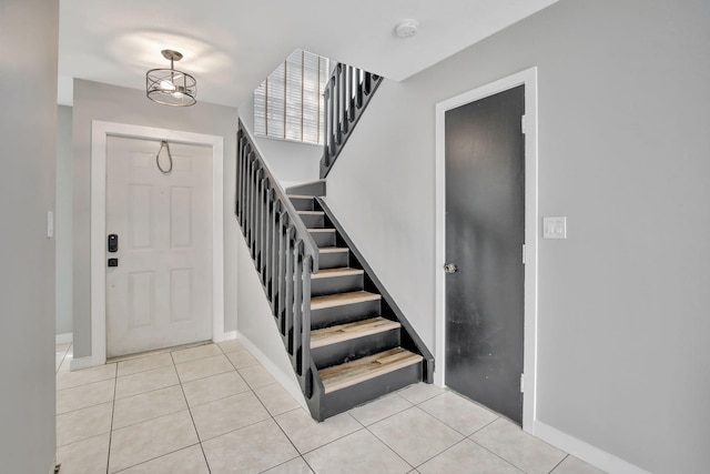 entrance foyer featuring an inviting chandelier and light tile patterned flooring