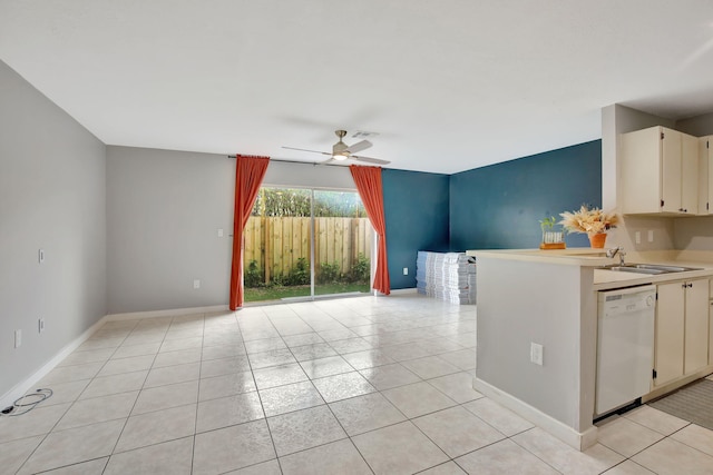 kitchen featuring cream cabinets, dishwasher, sink, light tile patterned floors, and ceiling fan