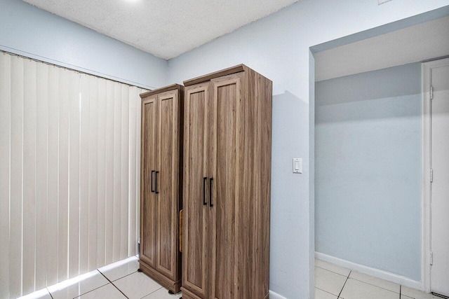 hall with light tile patterned floors