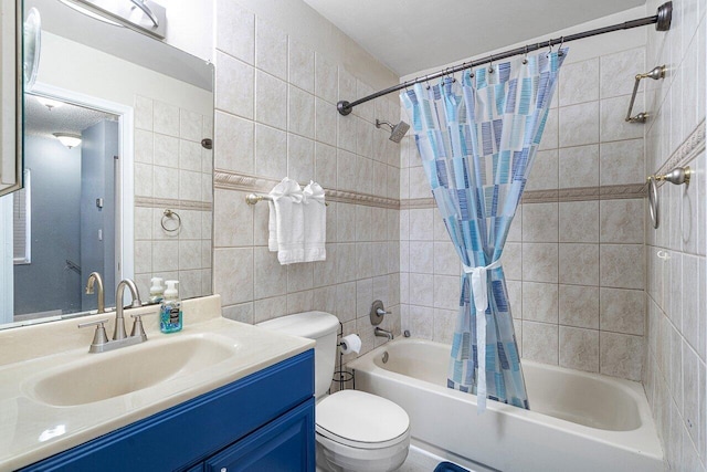 full bathroom featuring shower / bath combo with shower curtain, vanity, toilet, and tile walls