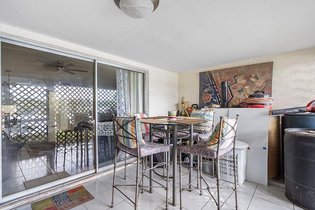 dining area with ceiling fan and light tile patterned floors