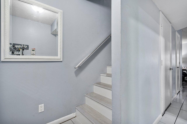 staircase with tile patterned flooring