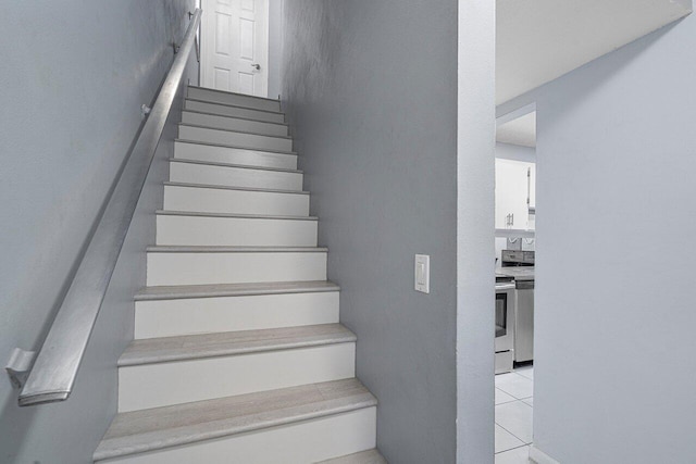 staircase featuring tile patterned flooring