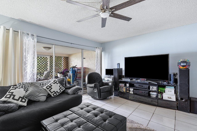 living room featuring a textured ceiling, light tile patterned floors, and ceiling fan