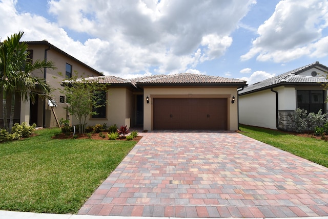 mediterranean / spanish-style house featuring a garage and a front lawn