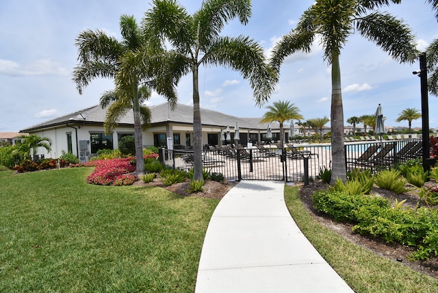 view of community with a pool and a yard