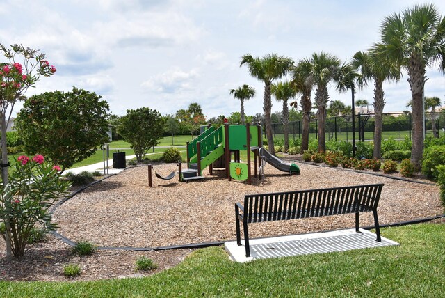 view of playground with a lawn