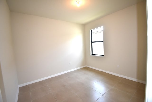 unfurnished room with light tile patterned flooring