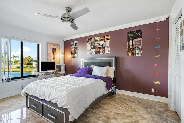 bedroom featuring a textured ceiling, a closet, ceiling fan, and crown molding