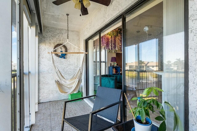 sunroom featuring ceiling fan