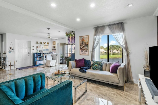 living room featuring ceiling fan and a textured ceiling