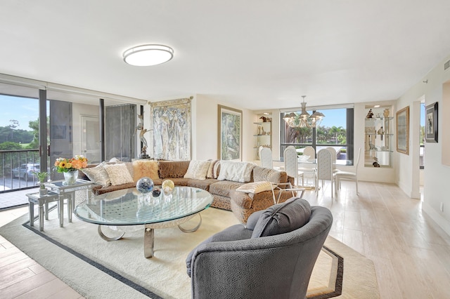 living room with light hardwood / wood-style floors and a wall of windows