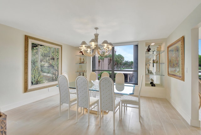 dining area featuring light hardwood / wood-style floors and an inviting chandelier