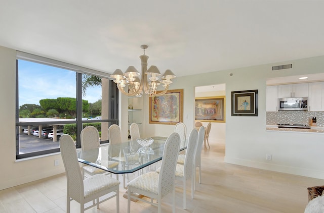 dining room with a chandelier and light hardwood / wood-style flooring