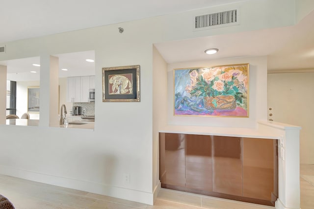 20100 Boca W Dr Unit 125, Boca Raton, FL 33434 - corridor featuring a sink and baseboards