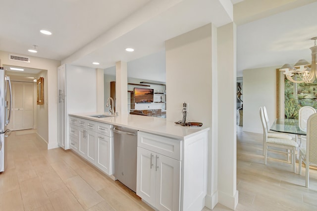 kitchen featuring sink, white cabinets, stainless steel appliances, and light hardwood / wood-style floors