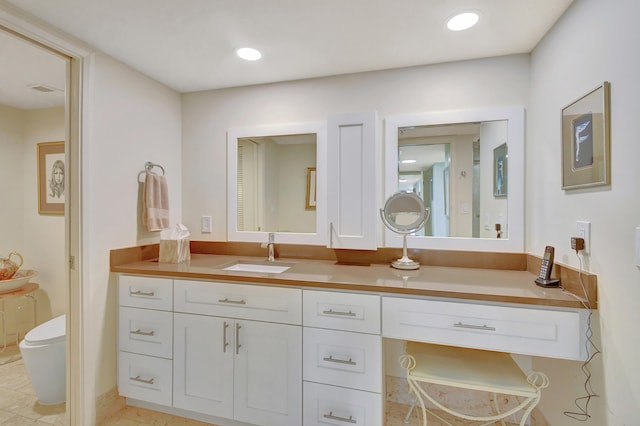 bathroom featuring tile patterned flooring, vanity, and toilet