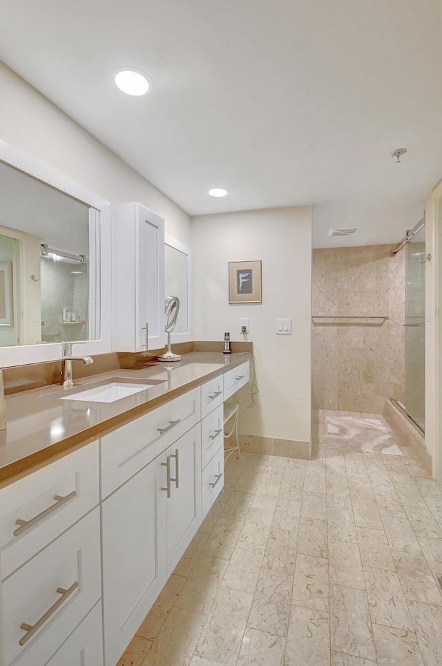 bathroom featuring vanity and a shower with shower door