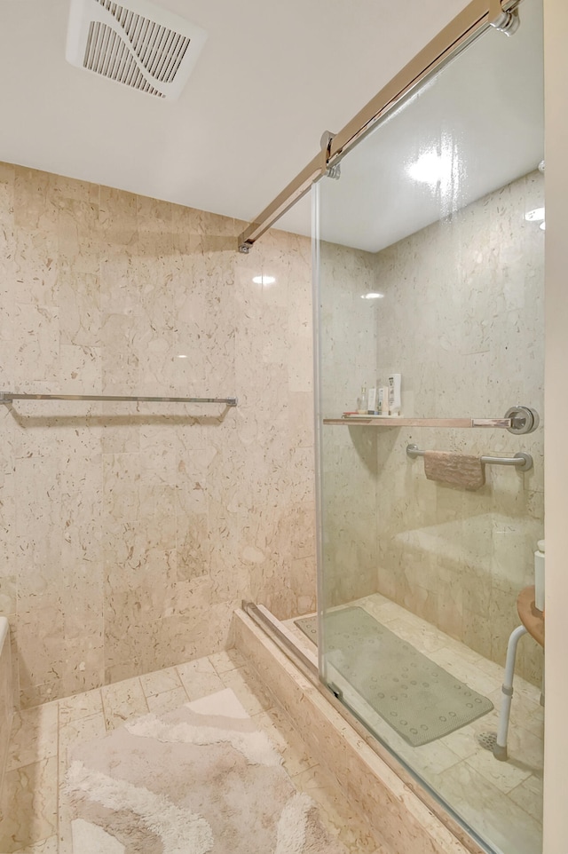 bathroom with a tile shower