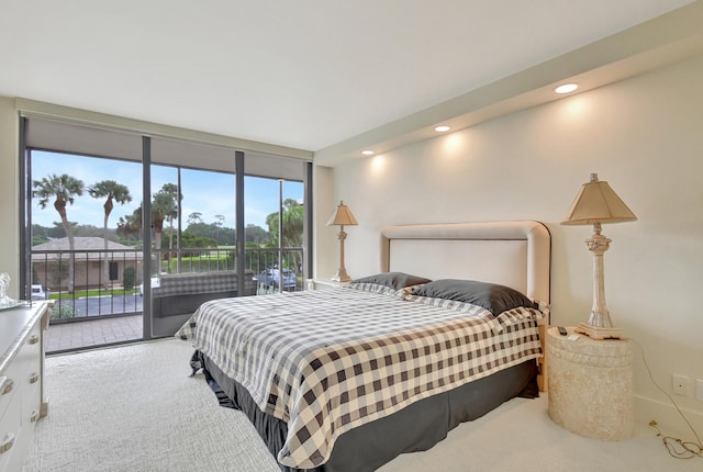 bedroom with access to outside and light colored carpet