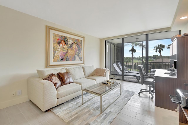 20100 Boca W Dr Unit 125, Boca Raton, FL 33434 - living room with a desk, baseboards, and expansive windows