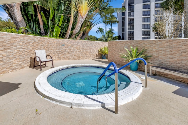 view of pool with a community hot tub and a patio