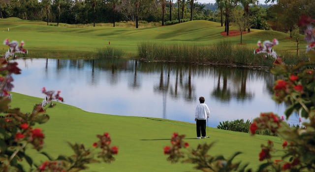 20100 Boca W Dr Unit 125, Boca Raton, FL 33434 - view of community featuring view of golf course, a water view, a yard, and view of wooded area