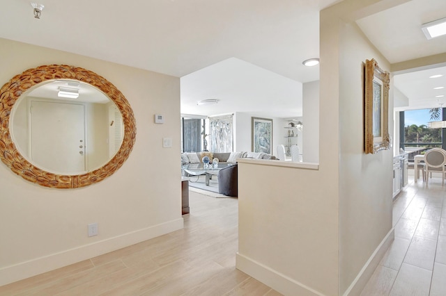 20100 Boca W Dr Unit 125, Boca Raton, FL 33434 - hall with baseboards and light wood finished floors
