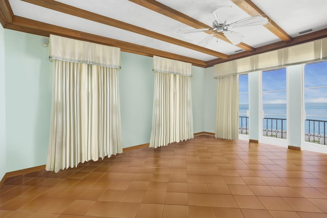 unfurnished room featuring ceiling fan, beamed ceiling, and a water view