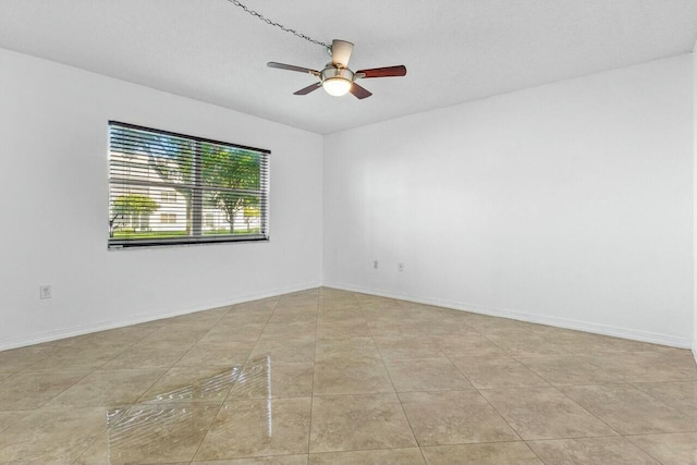 unfurnished room featuring a textured ceiling, ceiling fan, and light tile patterned flooring