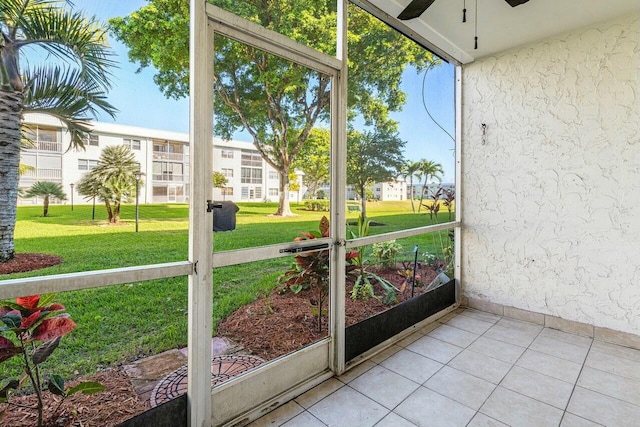 unfurnished sunroom featuring ceiling fan