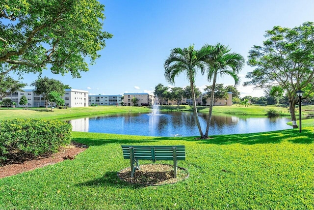 surrounding community featuring a yard and a water view